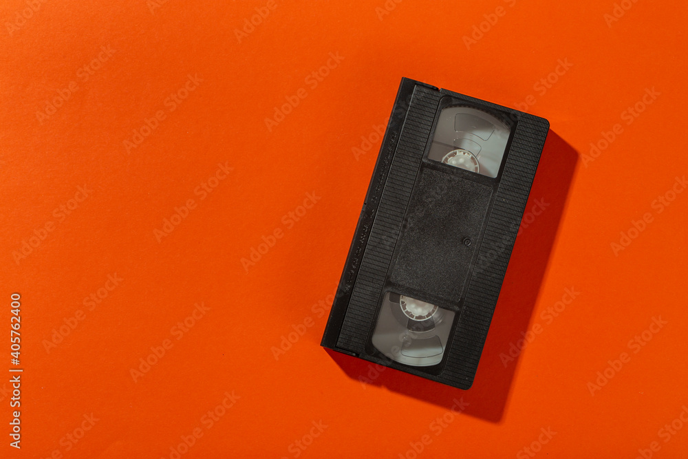 A videotape without a cover on an orange background. A videotape without a cover on an orange background.
