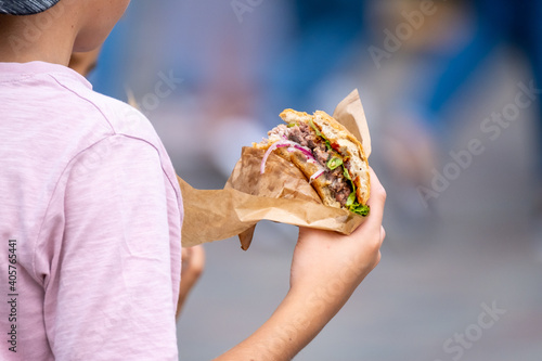 Anonymous child with delicious burger