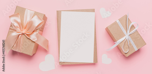 Gifts with note letter on isolated pink background, love and valentine concept © Daria Lukoiko