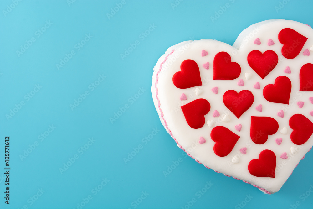 Heart cake for St. Valentine's Day, Mother's Day, or Birthday, decorated with sugar hearts on blue background Heart cake for St. Valentine's Day, Mother's Day, or Birthday, decorated with sugar hearts on blue background