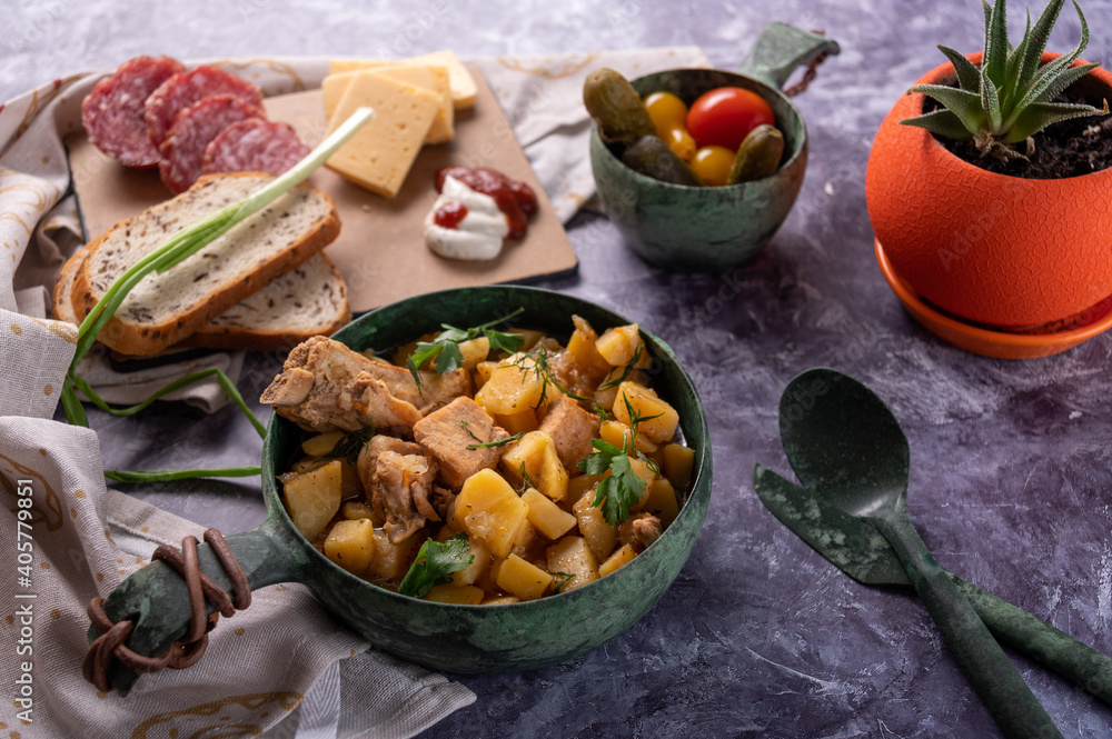 Kitchen table with food and flowerpot. Roast and canned vegetables. Serving food. Kitchen table with food and flowerpot. Roast and canned vegetables. Serving food.