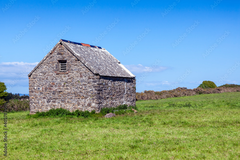 Stone barn shed in a summer pasture field on Caldey Island of the coast of Tenby Pembrokeshire South Wales, stock photo image Stone barn shed in a summer pasture field on Caldey Island of the coast of Tenby Pembrokeshire South Wales, stock photo image