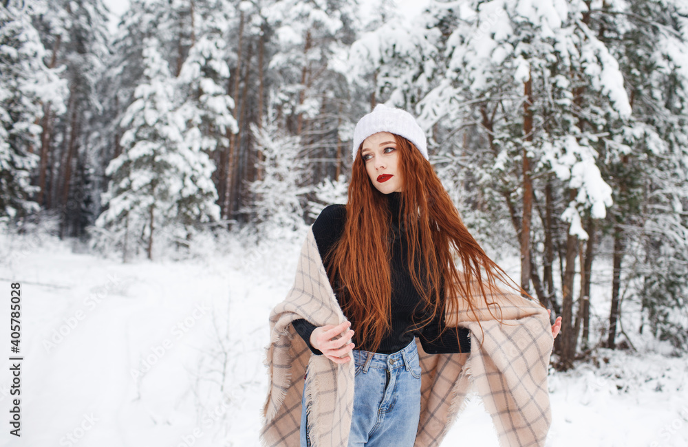 A young girl with long bright red hair on a winter background.A red-haired woman in a white cap. A young girl with long bright red hair on a winter background.A red-haired woman in a white cap.