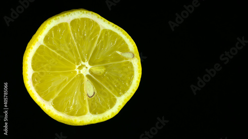 Sliced ​​lemon on a black background, close-up. template for text