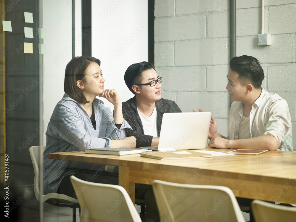 team of young asian entrepreneurs discussing business in office team of young asian entrepreneurs discussing business in office