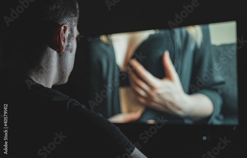 Man watching erotic film late at night. photo