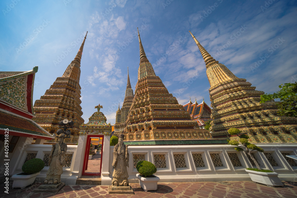 Fototapeta premium Beautiful stupas decorated with colorful mosaic big pagoda and Thai art architecture of Wat Pho temple in Bangkok, Thailand.