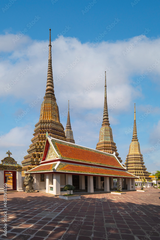Fototapeta premium Beautiful stupas decorated with colorful mosaic big pagoda and Thai art architecture of Wat Pho temple in Bangkok, Thailand.