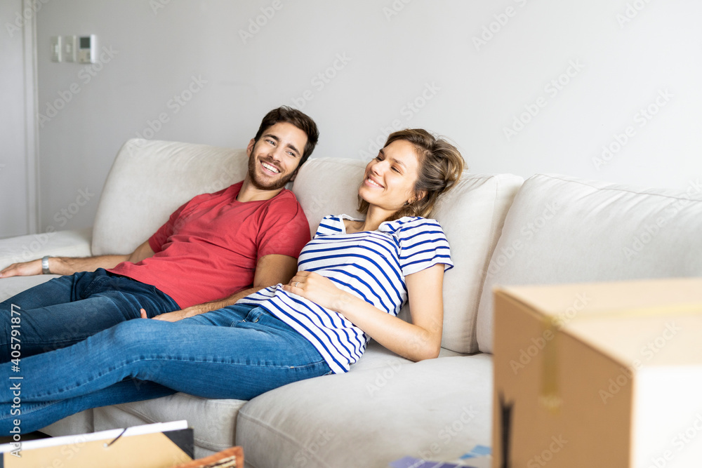 Young couple relaxing on sofa in their new house Young couple relaxing on sofa in their new house