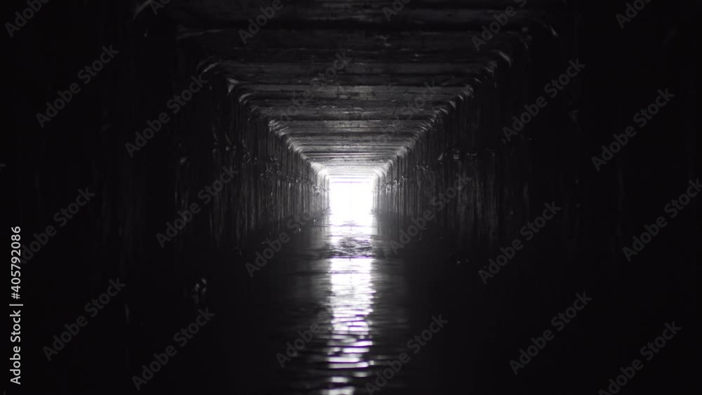 Exit from the drainage sewage rectangular tunnel. Empty concrete Drainage collector of city sewage system, timelapse. Exit from the drainage sewage rectangular tunnel. Empty concrete Drainage collector of city sewage system, timelapse.