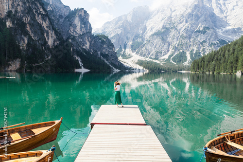 the girl standing on the dock of the lake Braies  Italy  minimalism