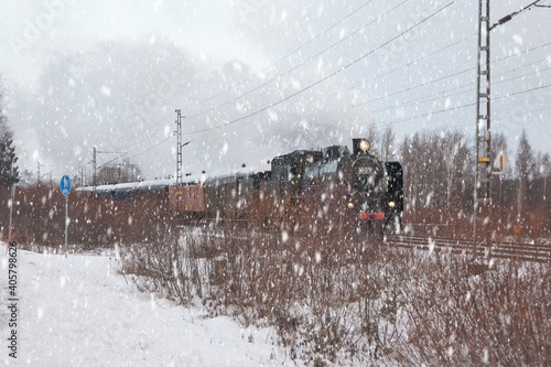 KOUVOLA, FINLAND - DECEMBER 26, 2018: Steam train Ukko-Pekka going from Kouvola to Kotka. The steam locomotive Hr1 1009 was made in 1948 and restored in 1993 photo