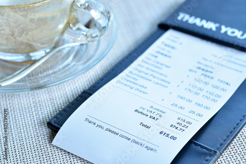 Close-up view, Food receipt bill with coffee cup.