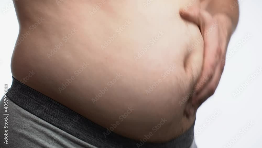 Close up fat man touch the Belly doing massage shaking. He very fat and has problem with stomach ache because he eat to much. Close up fat man touch the Belly doing massage shaking. He very fat and has problem with stomach ache because he eat to much.
