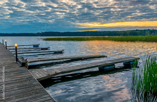 Wooden pier and footpath for fishing boats, morning in a big lake during sunrise