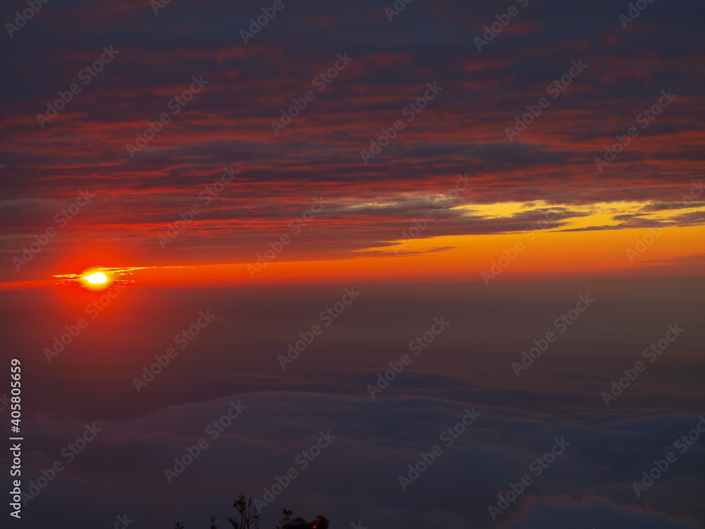 sunset with sea of clouds over the high-altitude mountains