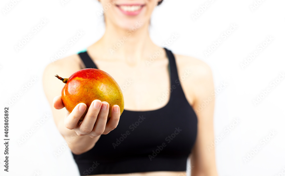 Smiling young woman presenting mango over white background. Healthy food and lifestyle concept.
Smiling young woman presenting mango over white background. Healthy food and lifestyle concept.
