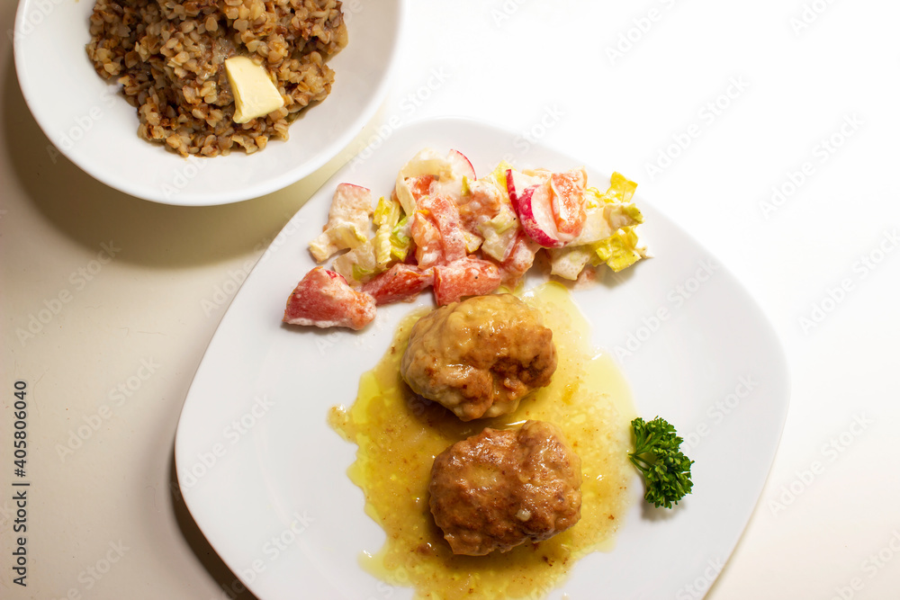 pork cutlets with buckwheat porridge garnish on a white background pork cutlets with buckwheat porridge garnish on a white background
