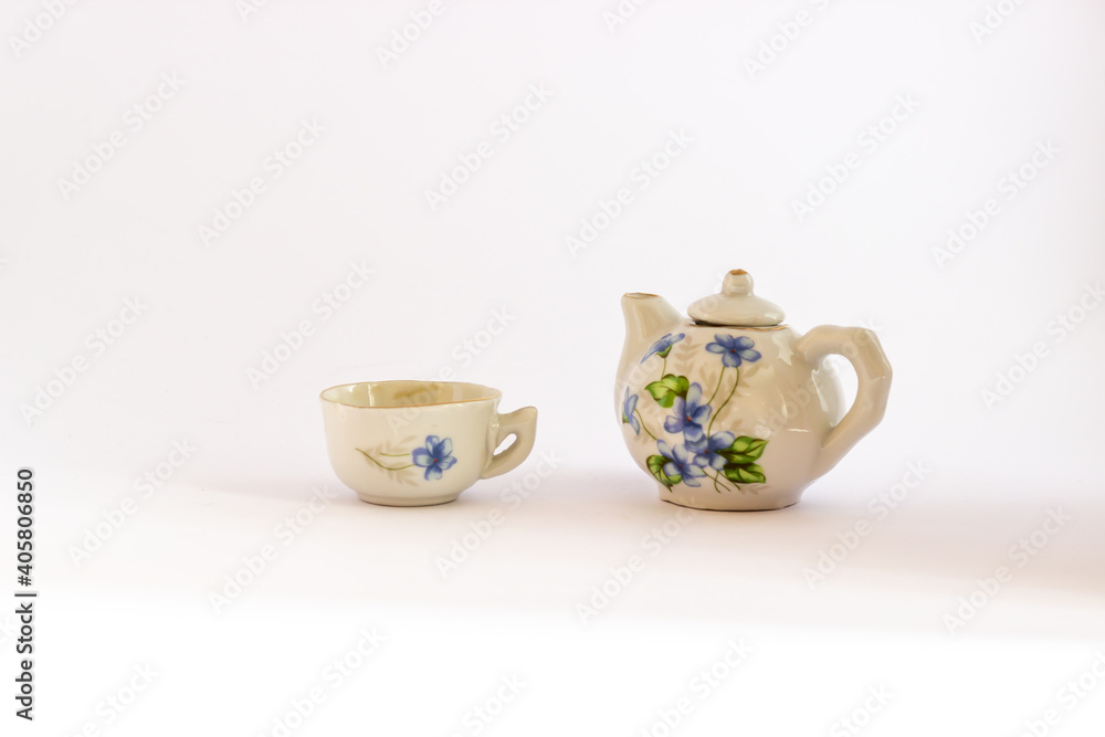 Ceramic mini tea set isolated on white background. Miniature blue and white ceramic tea set. Ceramic mini tea set isolated on white background. Miniature blue and white ceramic tea set.