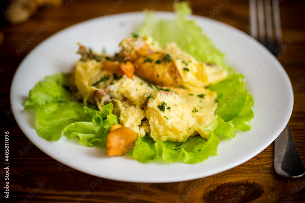 fried omelet with forest mushrooms chanterelles, on table fried omelet with forest mushrooms chanterelles, on table