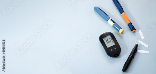 Digital glucometer and insulin pen. Health care concept, diabetes control. Web banner