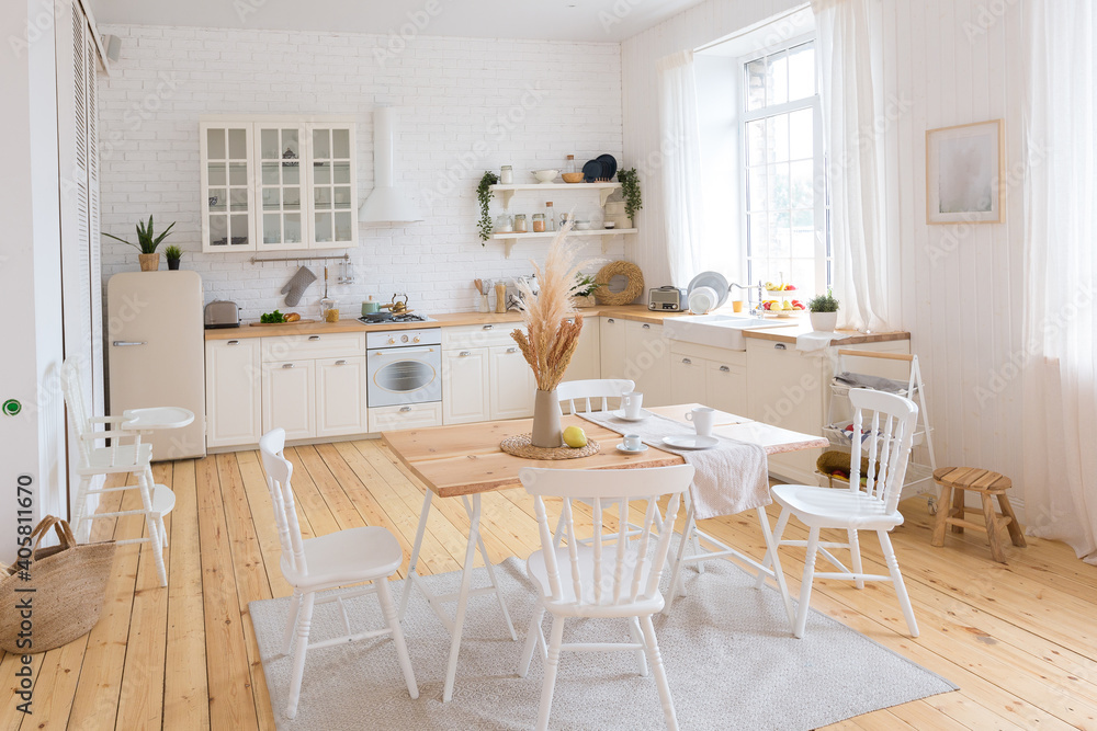 Fototapeta premium cute cozy light interior design of the apartment with a free layout of the kitchen and bedroom areas. a lot of windows, a wooden floor and a hanging swing.