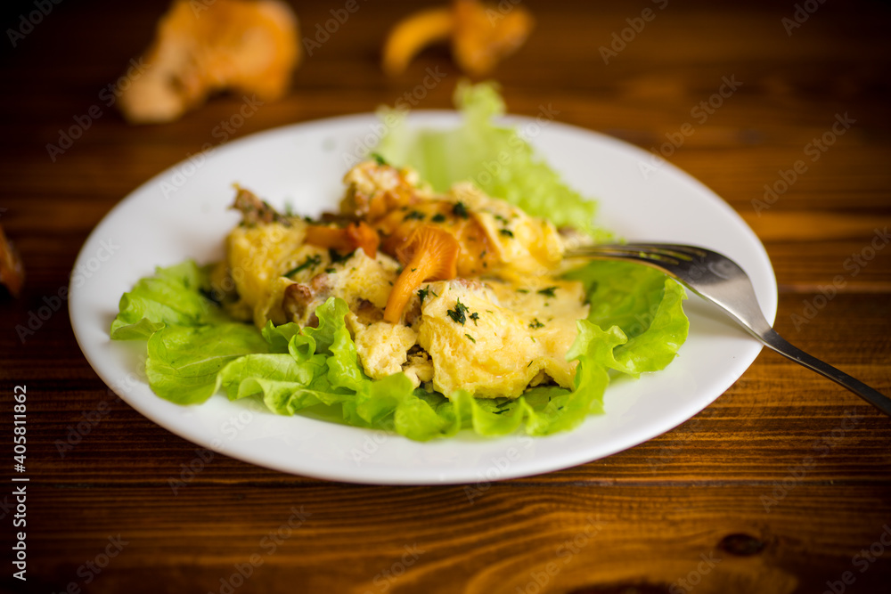 fried omelet with forest mushrooms chanterelles, on table fried omelet with forest mushrooms chanterelles, on table