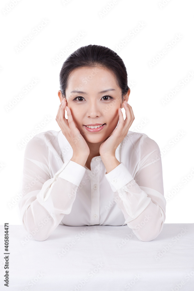 Portrait of young female office worker with hands on chin Portrait of young female office worker with hands on chin