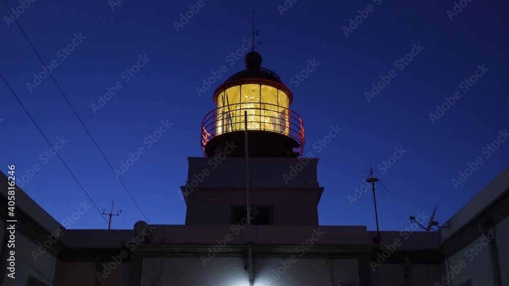 Symmetrical shot of a lighthouse with dark blue sky in the background at dusk, Ponta do Pargo, Madeira, Portugal Symmetrical shot of a lighthouse with dark blue sky in the background at dusk, Ponta do Pargo, Madeira, Portugal