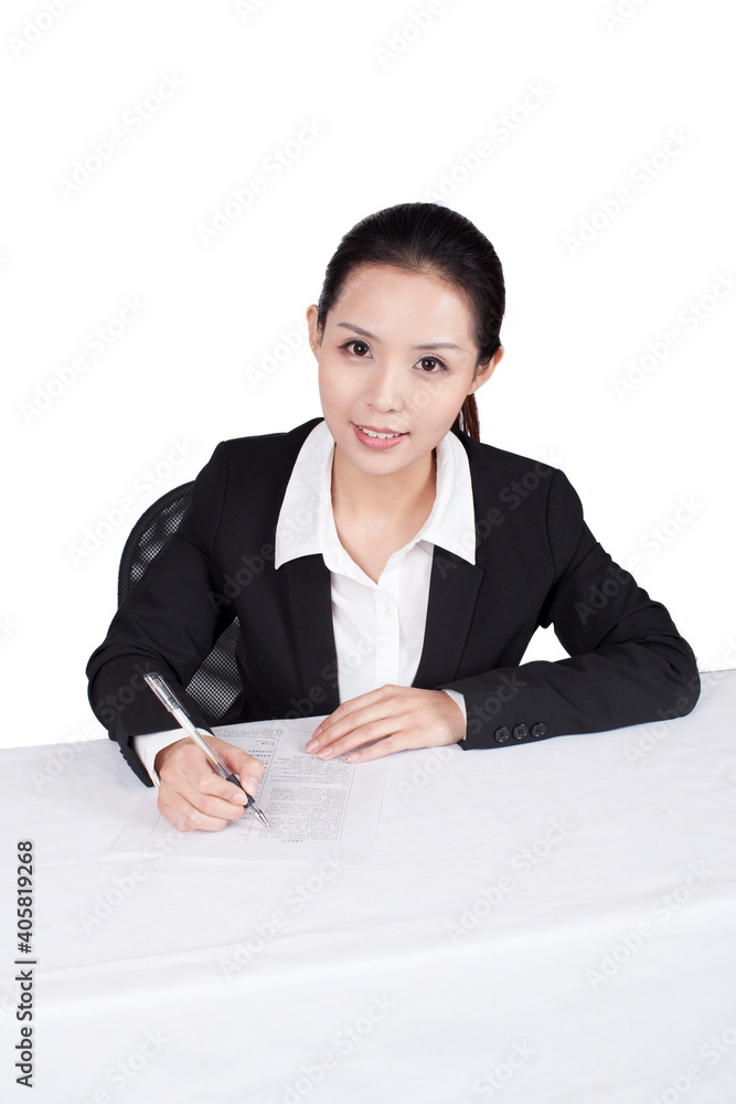 Businesswoman writting at a table with smile Businesswoman writting at a table with smile