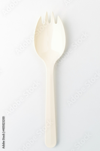 Plastic spork on white background
