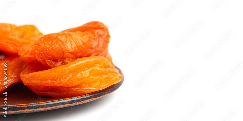 Dried apricots fruit in a plate, isolated on white background, close up view Dried apricots fruit in a plate, isolated on white background, close up view
