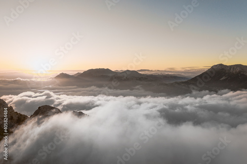 Aerial view above the cliffs and mountains meeting the sky and clouds. Picturesque landscape. Majestic nature in Turkey