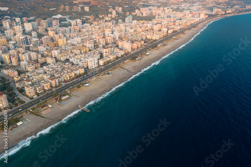 Aerial view of the Antalya city. Mediterranean sea, and the coast of Antalya. Mountains and sky in the background. Turkey