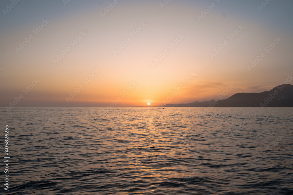 Beautiful sea with sunset sky and sun through the clouds over. Meditation ocean and sky background. Tranquil seascape. Horizon over the water.