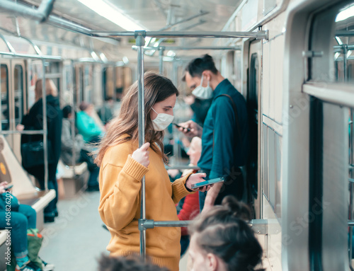 variety of passengers ride the subway car