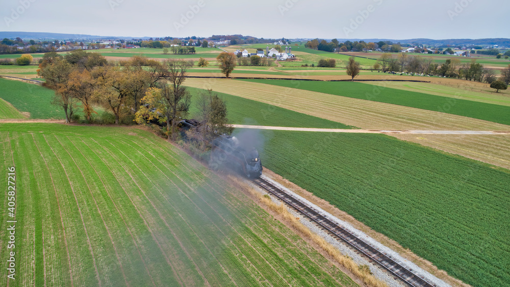 Aerial View of a Restored Antique Steam Locomotive Pulling a Caboose on a Sunny Fall Day