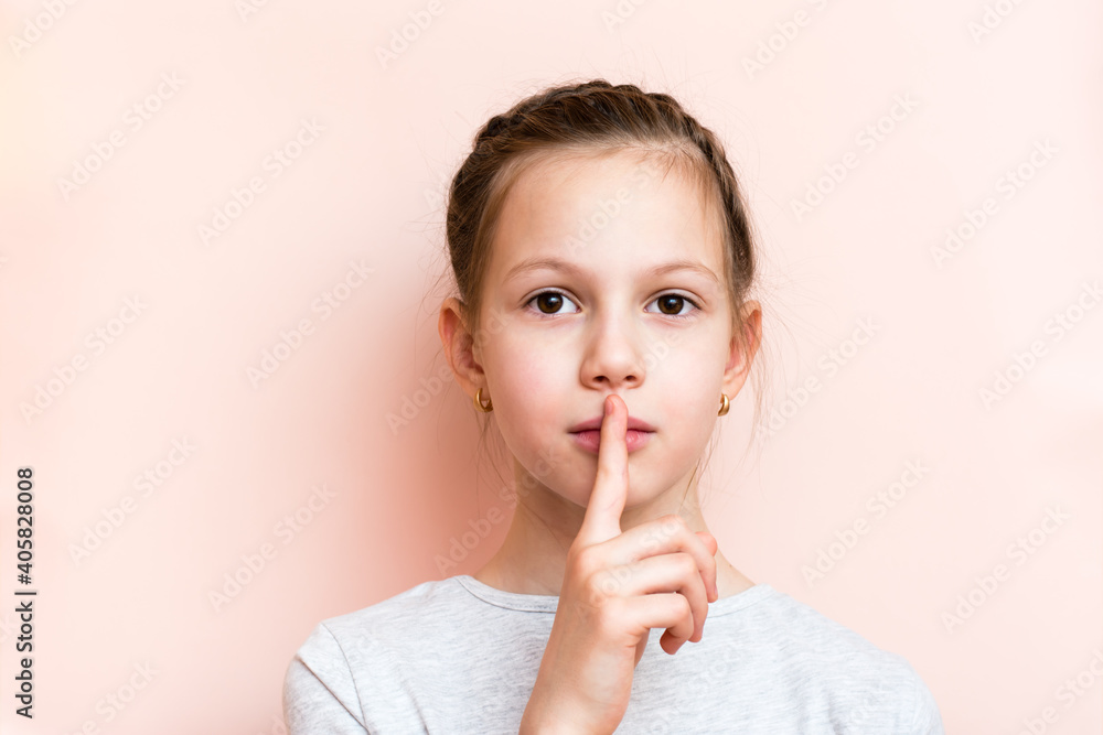 Surprised girl holds her finger in front of her lips. Call for silence Surprised girl holds her finger in front of her lips. Call for silence