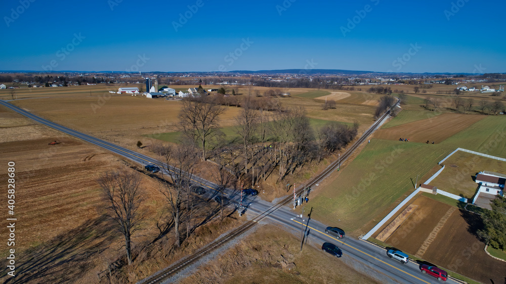 Aerial View of Farms and Fields Pulse a Rail Road Track in Winter on a Cloudless Sky