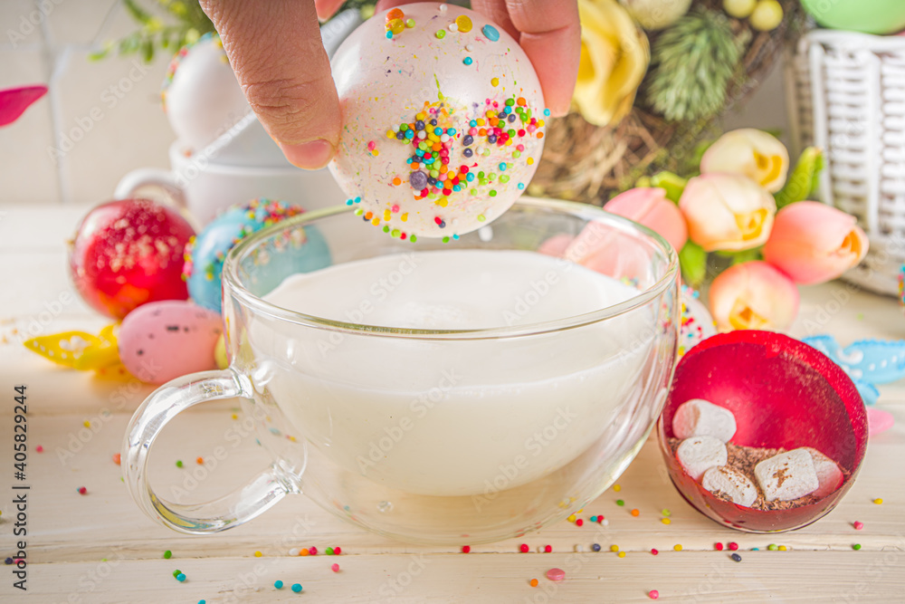 Festive Easter hot chocolate bomb. White chocolate bomb for hot cocoa drink, with marshmallow and sugar sprinkles Festive Easter hot chocolate bomb. White chocolate bomb for hot cocoa drink, with marshmallow and sugar sprinkles