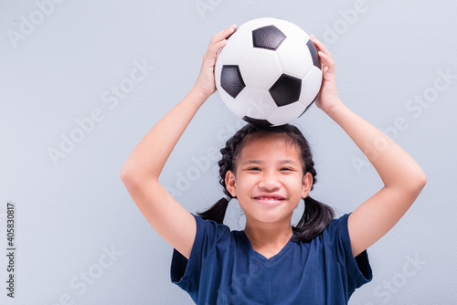 Happy Child with Ball on Head © patpitchaya
