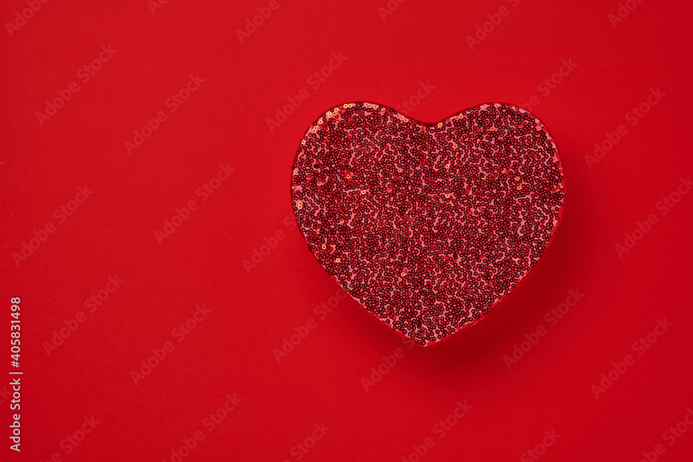 Beautiful red heart box for a luxurious gift embroidered with beads on a scarlet background. Valentines day postcard. Top view.