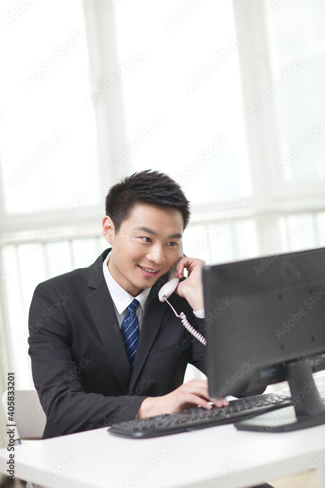 Portrait of business man sitting by computer Portrait of business man sitting by computer