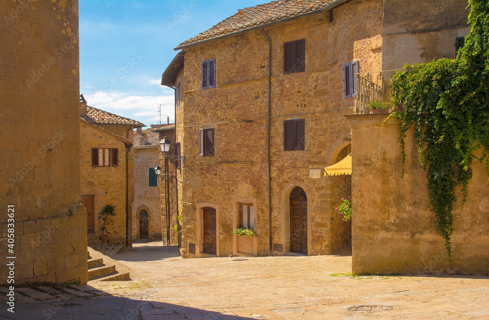 Old residential buildings in a square in the historic centre of the medieval town of Monticchiello near Pienza in Siena Province, Tuscany, Italy

