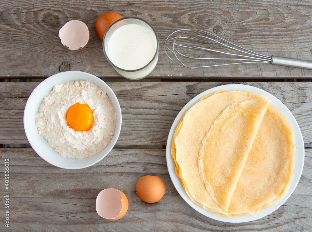 Flat composition with thin pancakes on wooden background Flat composition with thin pancakes on wooden background