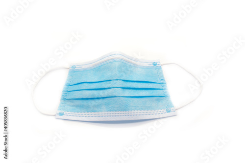 Medical protective blue mask on white background. Protection against coronavirus. Top view, isolated. 