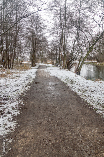 Path through trees at winter time next to Radunia canal in Pruszcz Gdanski. © Robson90