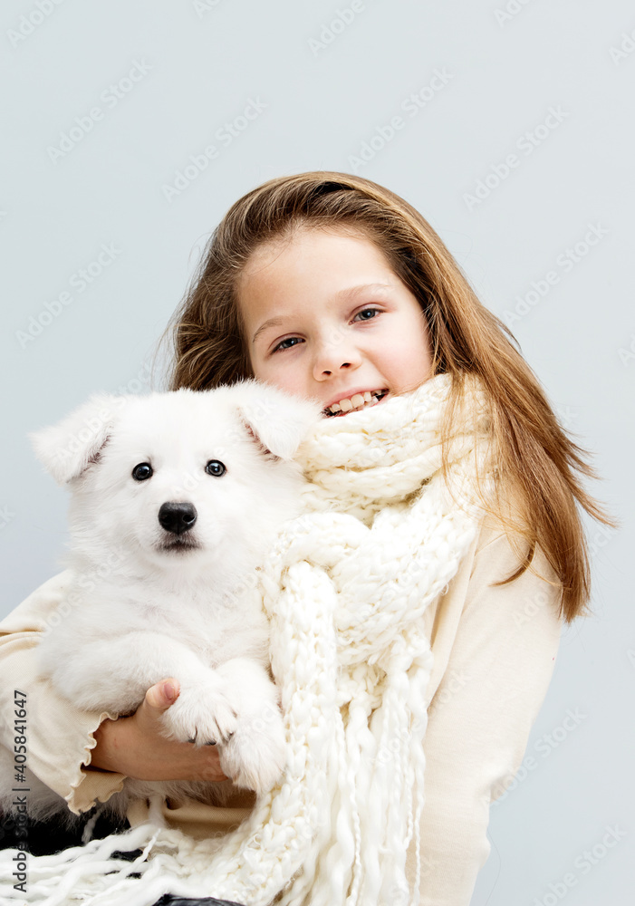 smiling child hugs white puppy smiling child hugs white puppy