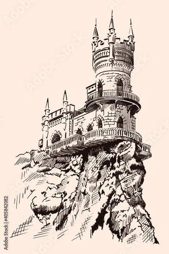 Medieval stone castle with towers and arches on a rocky cliff.