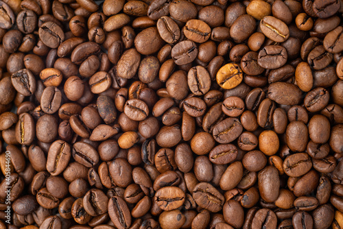 Roasted coffee beans covering the entire picture  creating a nice background.